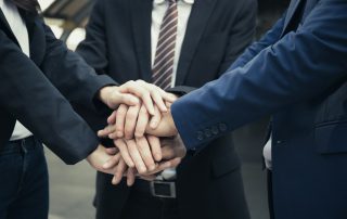 Business Partners Team with hands together. People with business team stacking hands together.