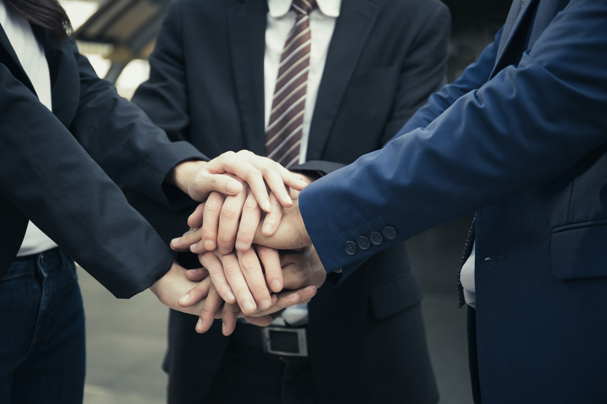 Business Partners Team with hands together. People with business team stacking hands together.